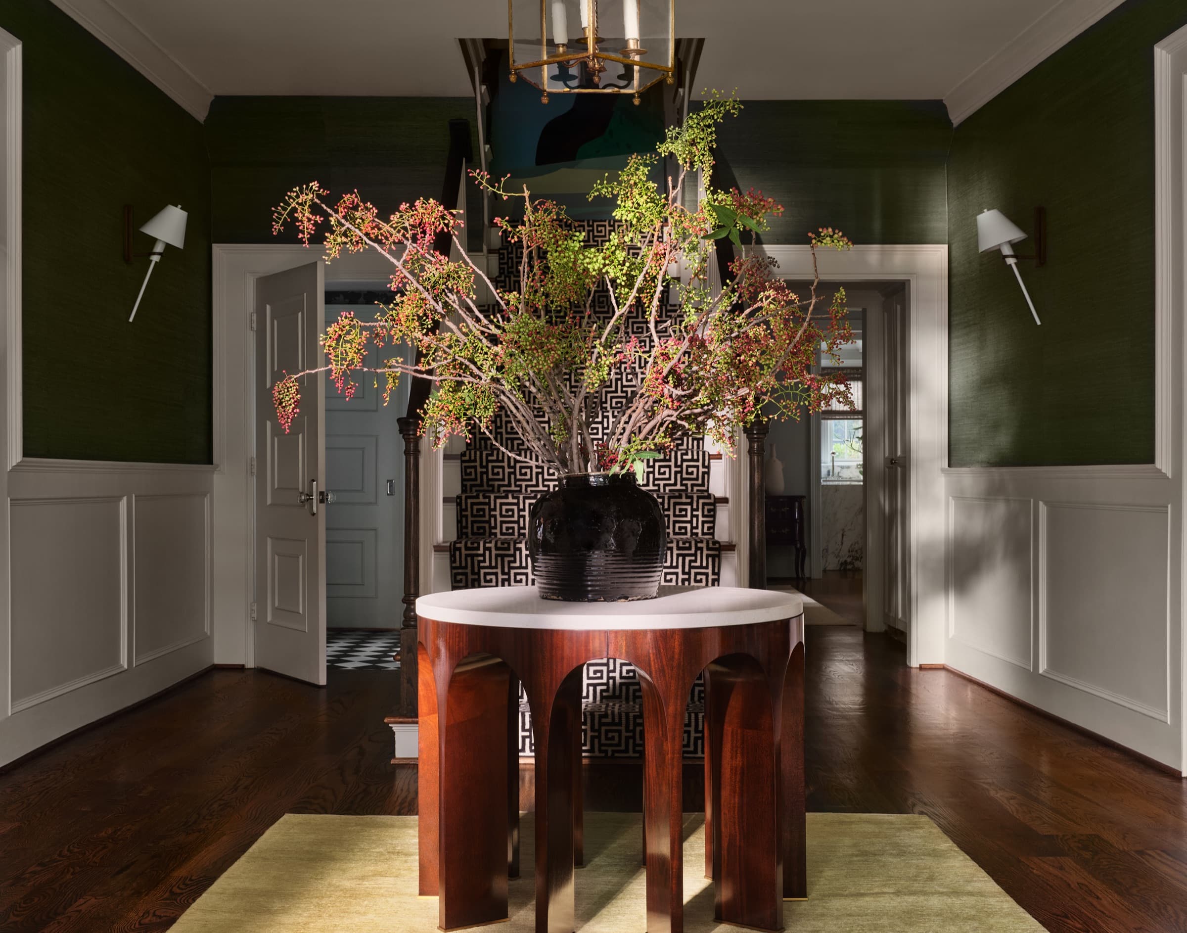 A composed living room balances high ceilings with grounded, tactile furniture.