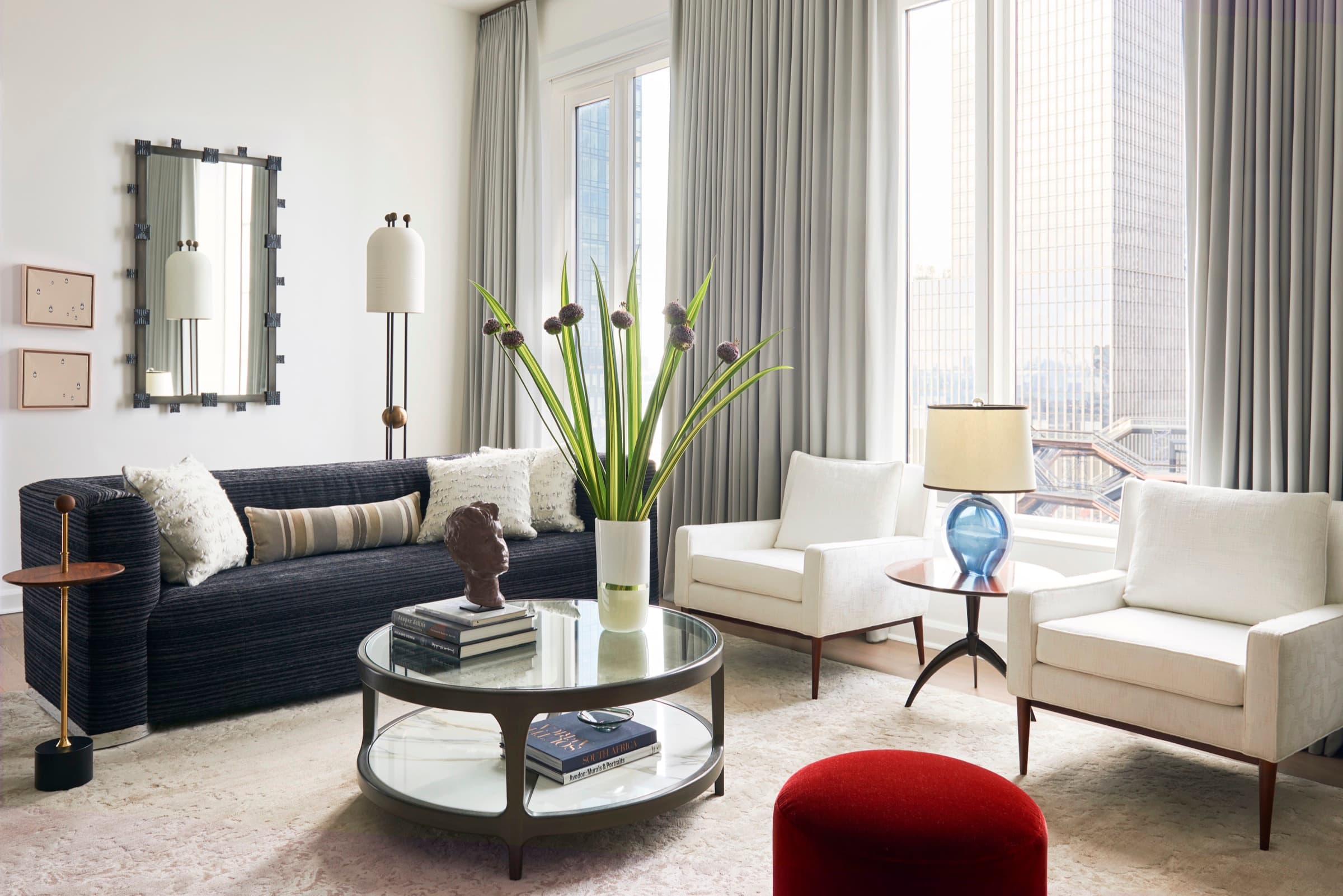 Custom wool sateen drapery softens the scale of the highrise glazing.