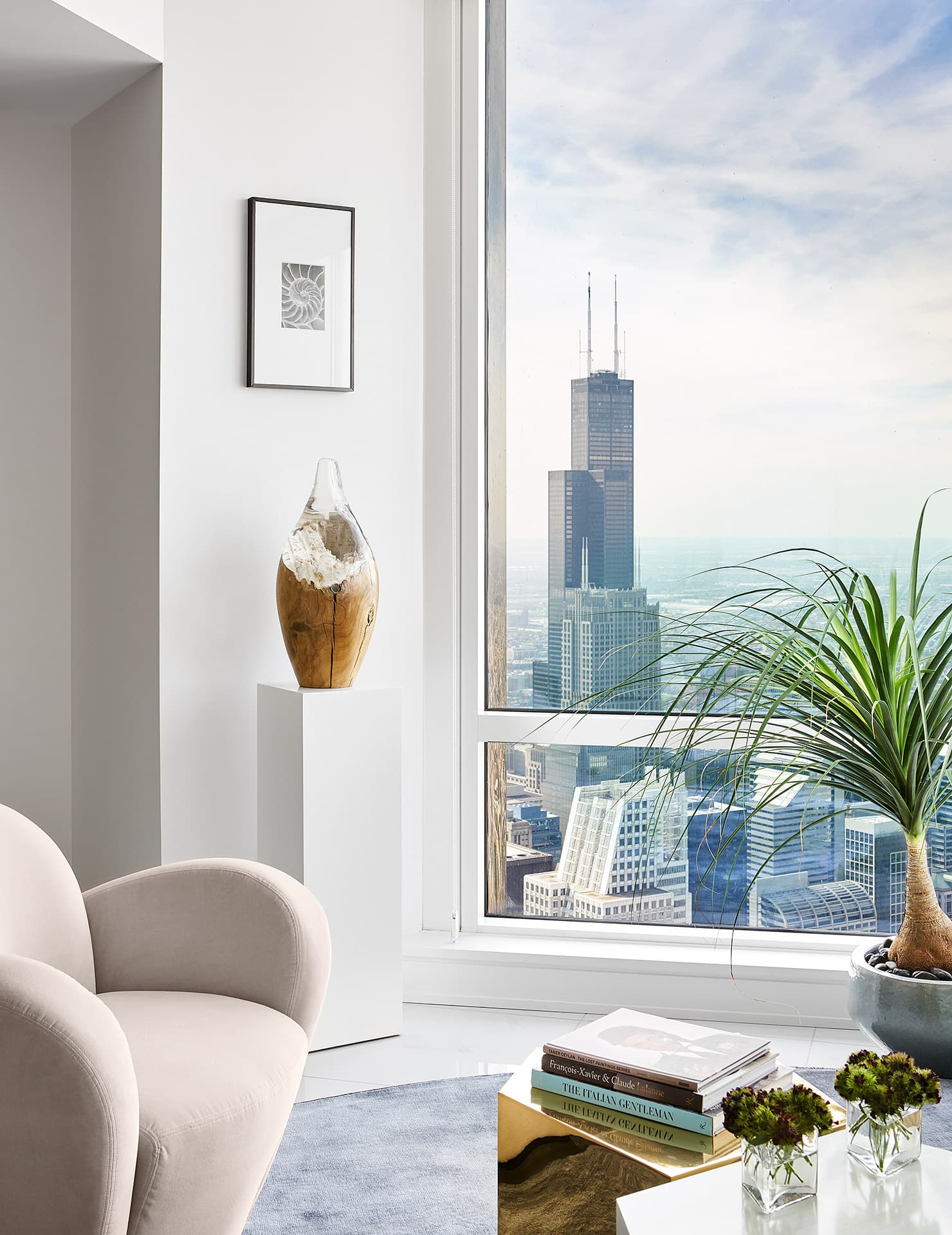 Curved seating and a saturated rug soften the penthouse perimeter.