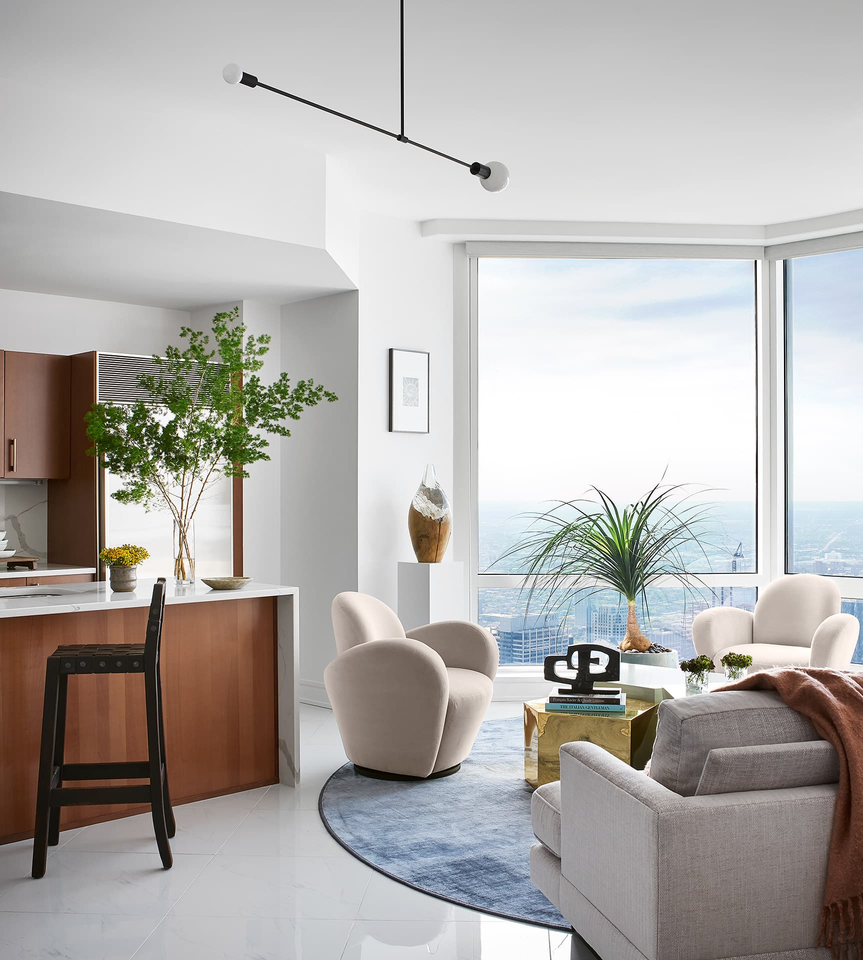 The skyline remains present, but the furnishings hold the room.
