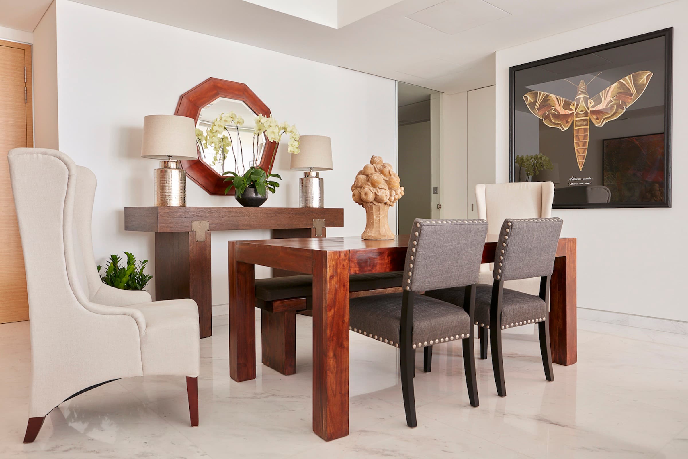 Dining balances polished architecture with warm wood and collected artwork.
