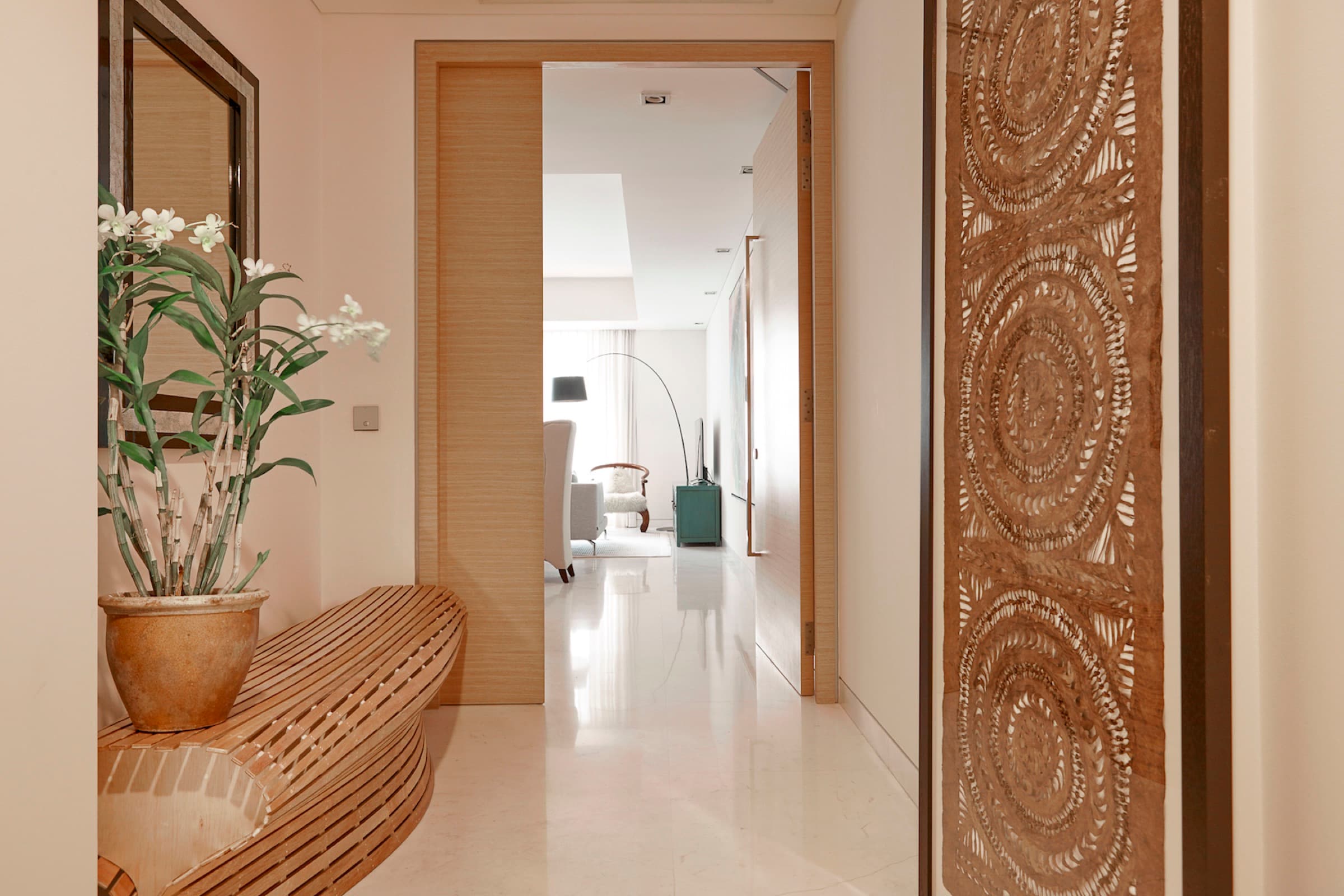 Entry details introduce texture and craft before the apartment opens to the view.