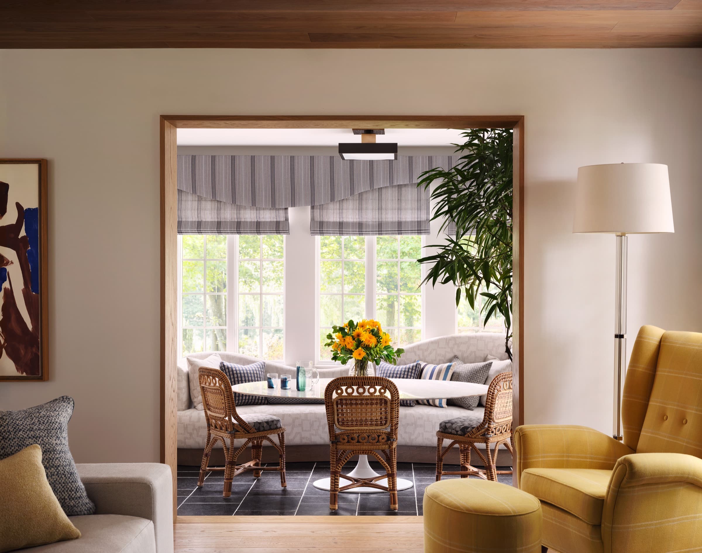 A paneled sitting room pairs collected objects with tailored upholstery and a composed art wall.