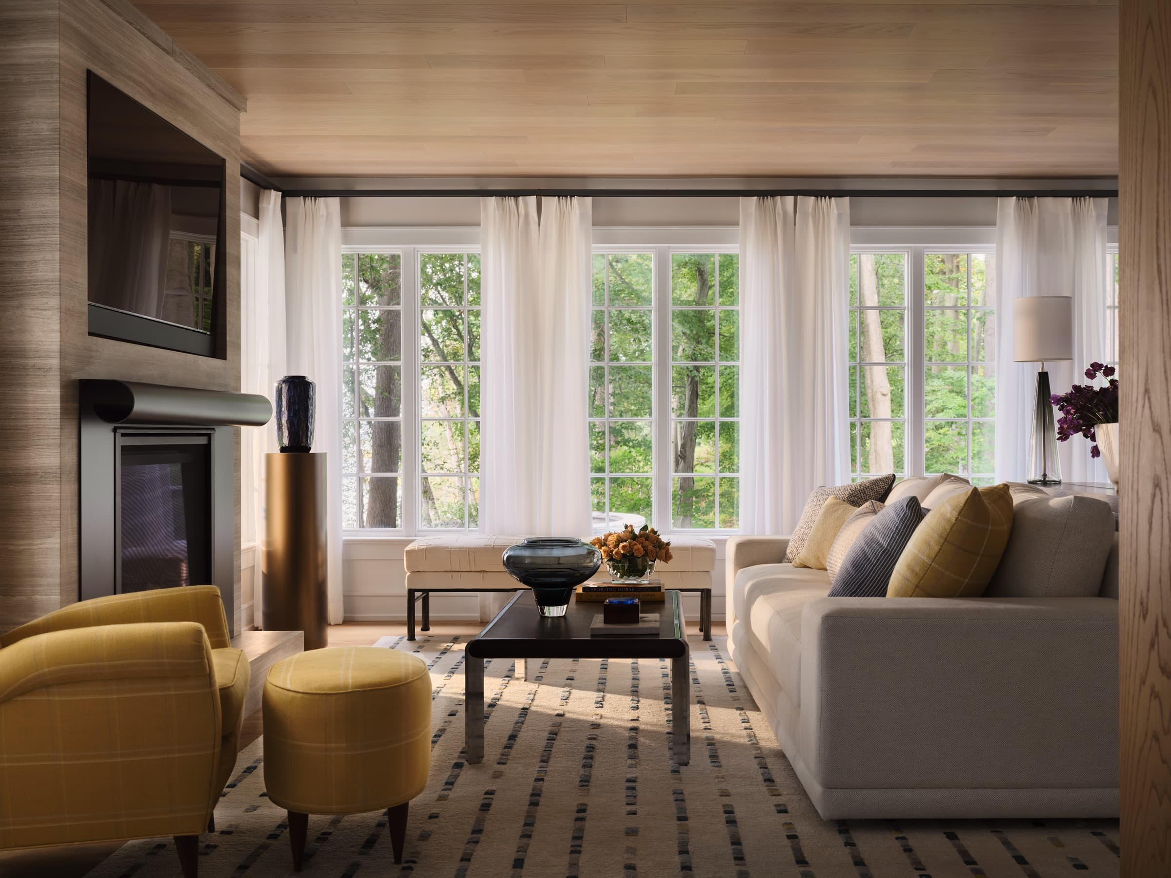 The primary bedroom is softened with layered textiles, tailored window treatments, and quiet color.