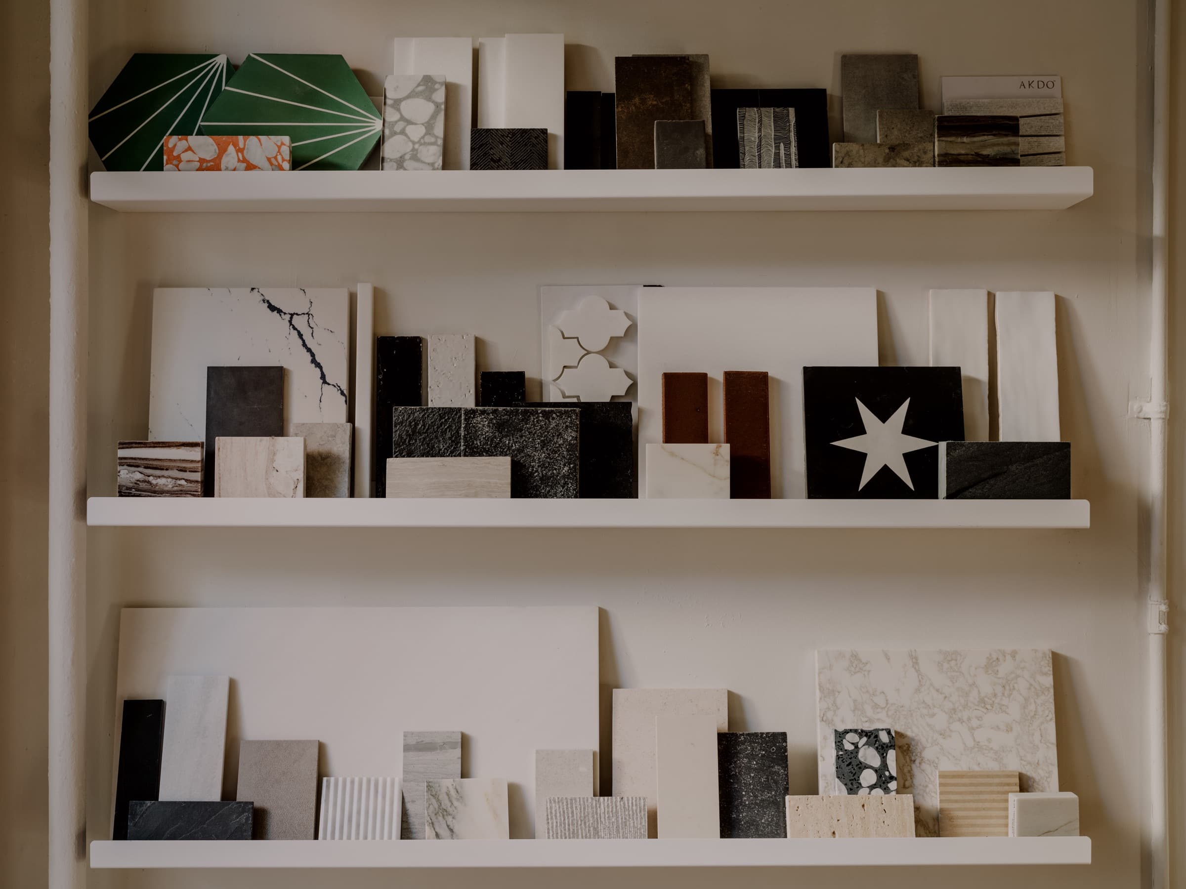 Peter Sandel Design studio material shelves with stone, tile, and finish samples