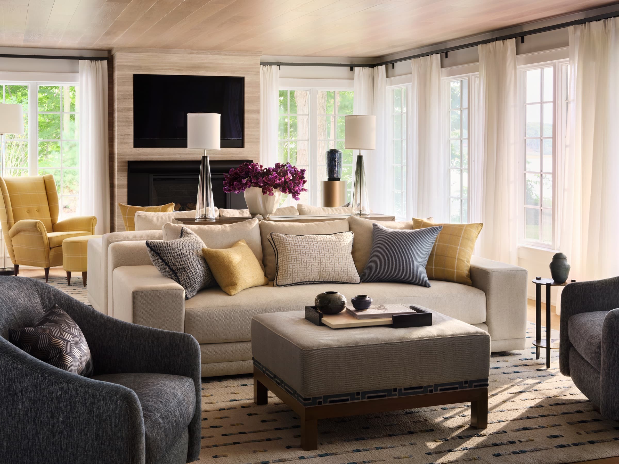 Head of the Harbor living room with layered textiles, yellow accents, and tailored upholstery